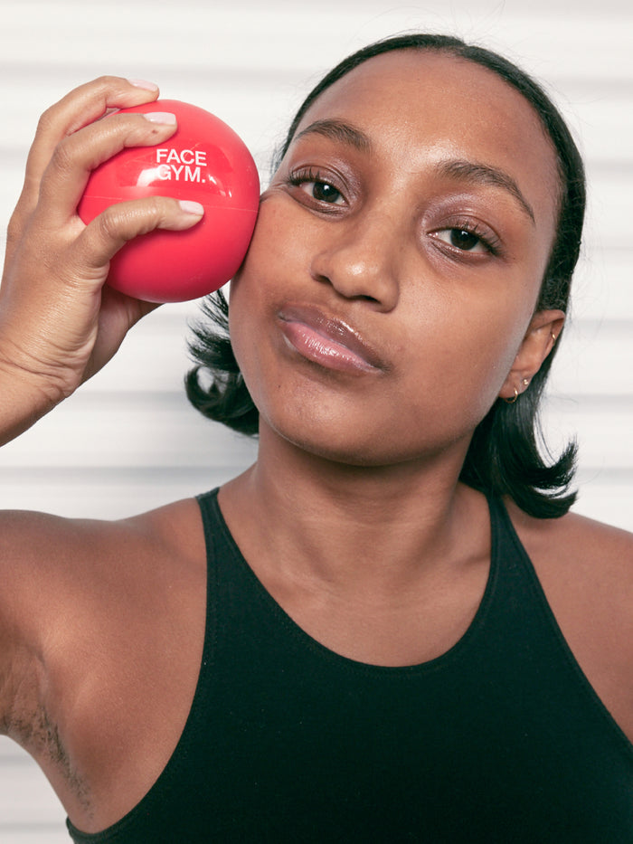 a woman holding a red ball