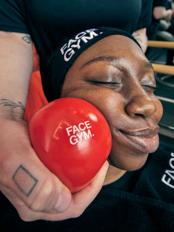 a woman holding a red ball
